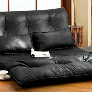 Roll out futon with 2 leather pillows.